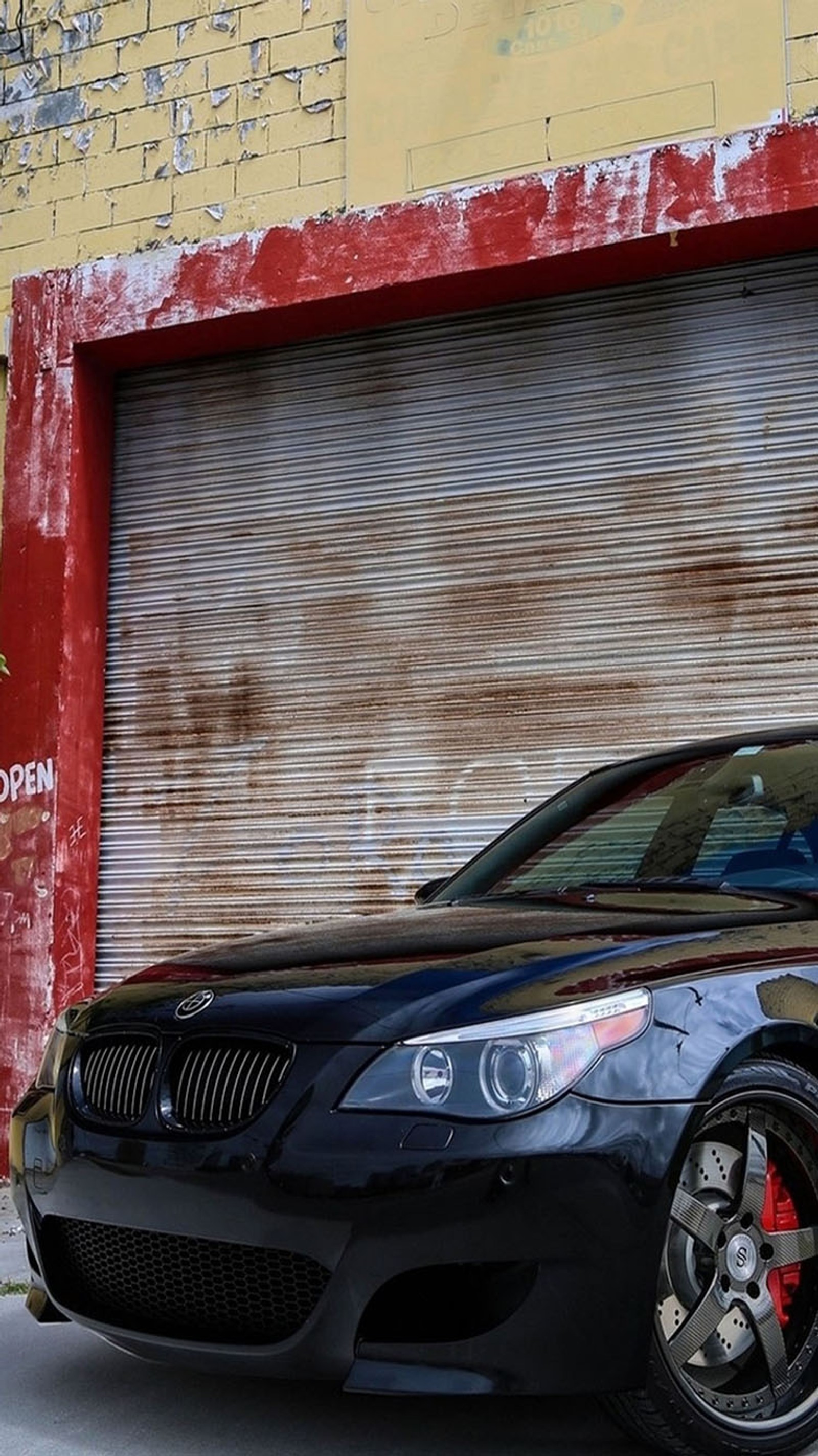 Arafed black sports car parked in front of a garage (bmw, m series)