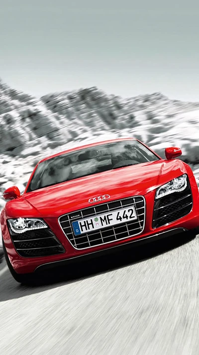 Audi R8 rojo dinámico en movimiento en una carretera montañosa