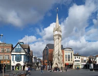 Historic Clock Tower Amidst a Bustling Urban Landscape