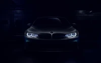 Illuminated Front View of a BMW Sports Car in Dark Setting