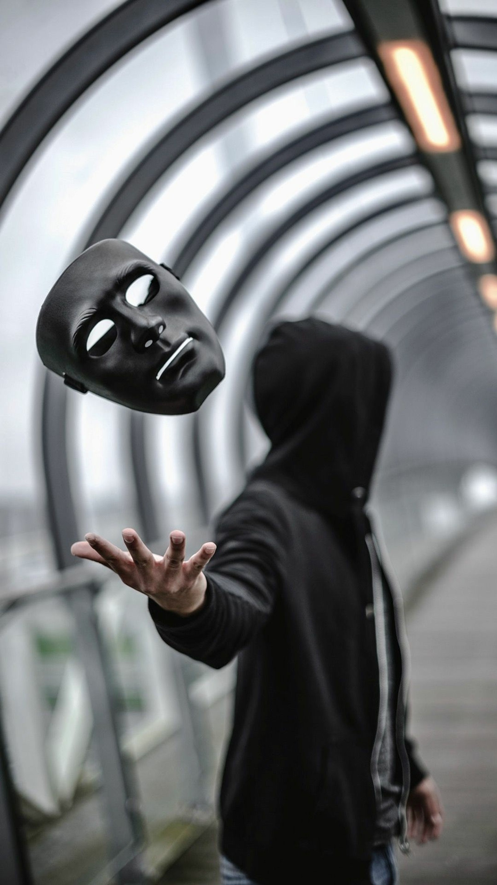 Arafed man in a black hoodie throwing a mask in the air (live, photography image, tumblr)