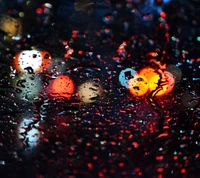 Nighttime Bokeh Drops: A Dance of Colorful Reflections