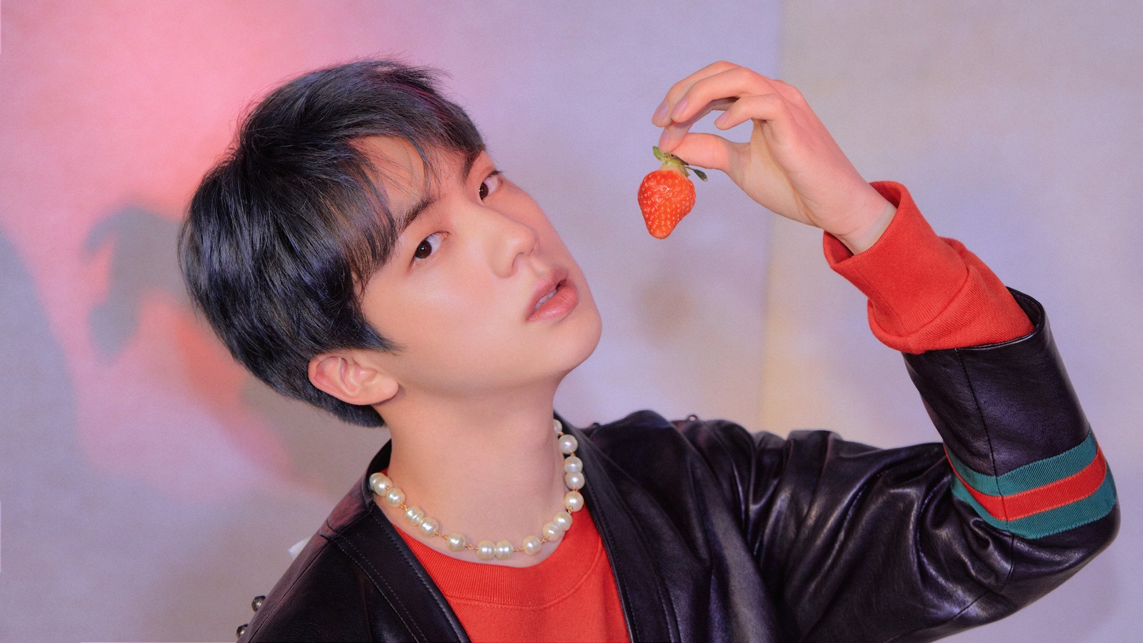 There is a man holding a carrot in his hand (jin, kim seok jin, bts, bangtan boys, kpop)