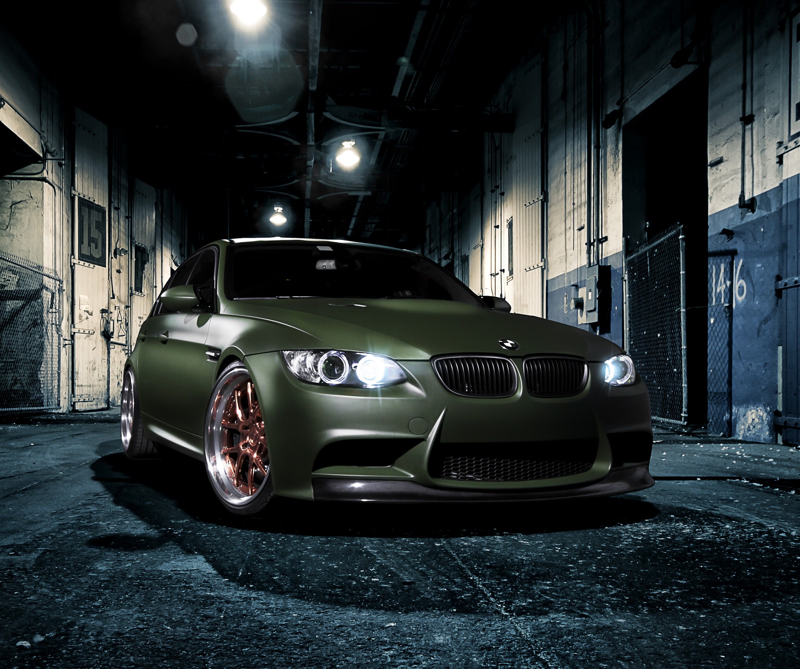 A close up of a car parked in a dark alley (bmw, car, green, power)