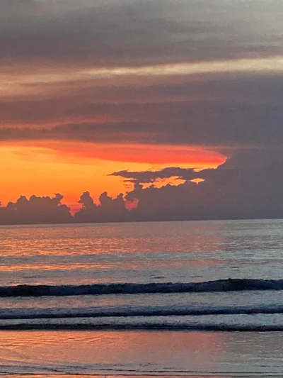 Tranquil Sunset Over the Horizon Reflecting on Calm Waters