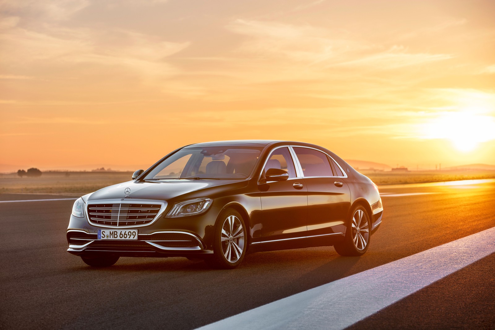 A black mercedes s - class driving on a road at sunset (maybach, car, mercedes benz, performance car, mid size car)