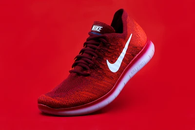 Nike Magenta Athletic Shoe on Red Background