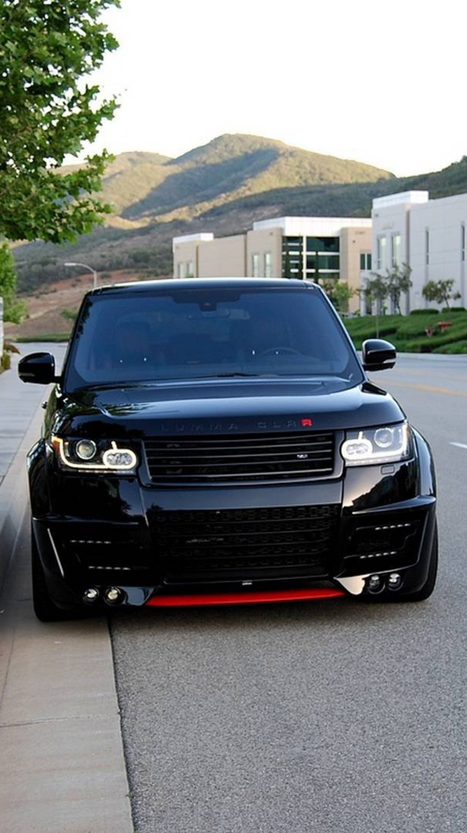 Arafed black suv parked on the side of the road near a curb (car, design, range rover)