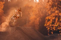 Dynamic Motorcycle Stunt Riding in Autumn Landscape