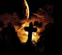 Silhouetted Cross Against a Fiery Sky and Celestial Body