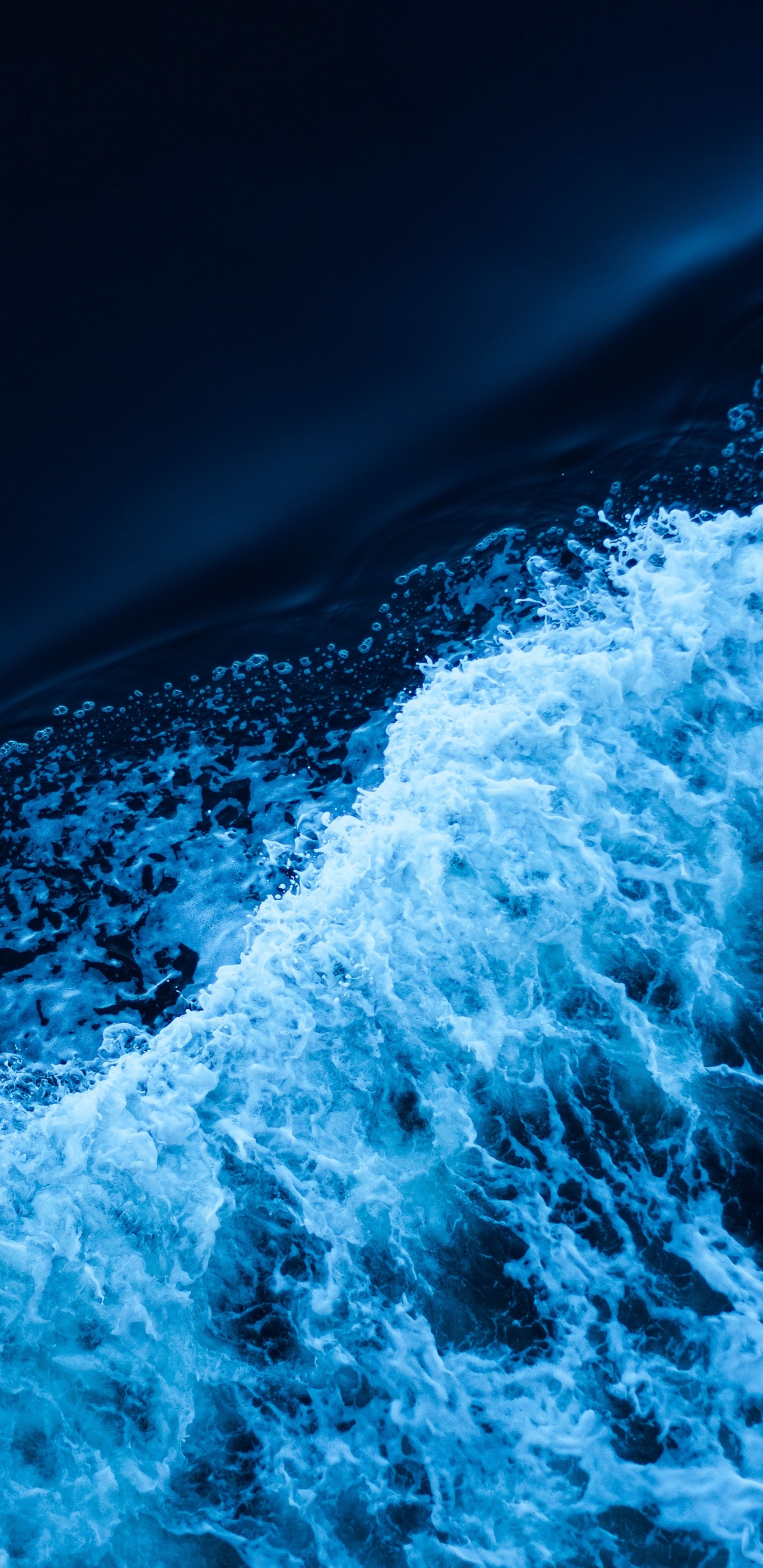 Arafed view of a body of water with a wave coming in (blue, ice, oceans, water, wave)