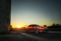 Dynamic Orange Supercar Against a Sunset Backdrop