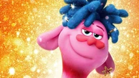 Prince D from Trolls World Tour with a playful expression against a glittering background.