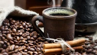 Artisan Coffee in a Rustic Mug Surrounded by Coffee Beans and Cinnamon Sticks