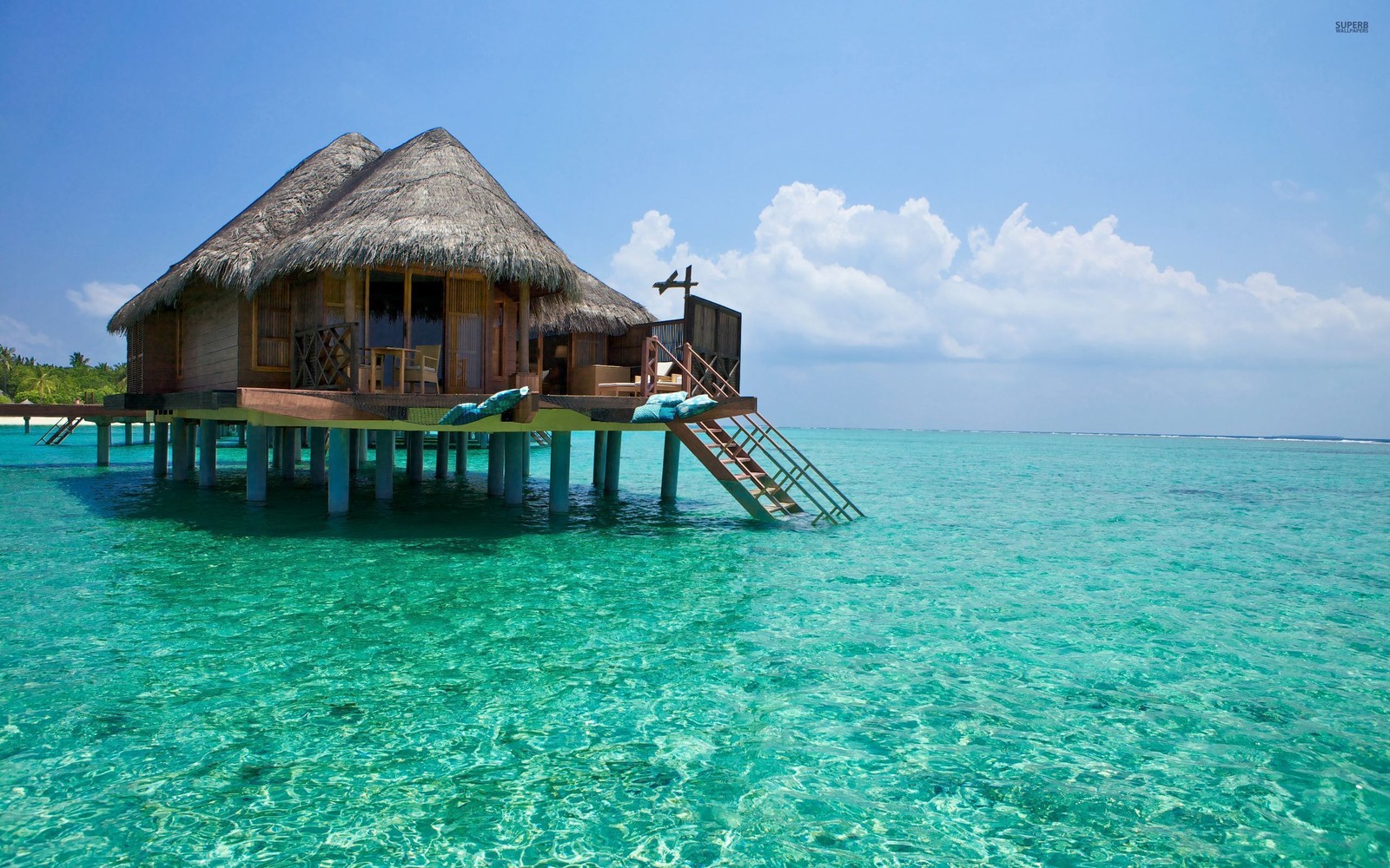 There is a small hut on the water with a slide (bali, island, tropics, lagoon, sea)