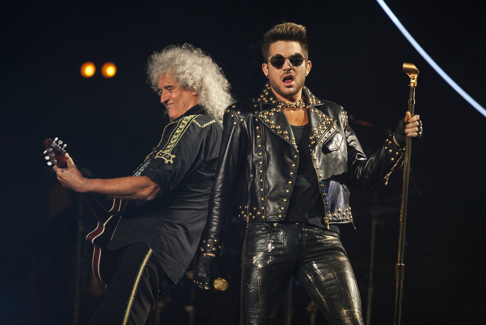 Arafed image of two men in leather outfits on stage (music artist, rock concert, queen, pop music, musician)