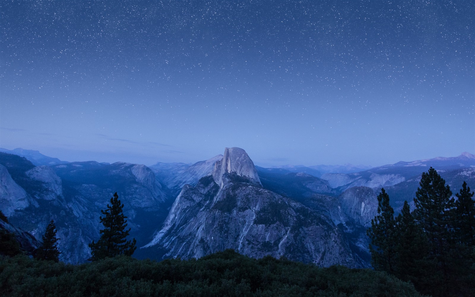 A view of a mountain range with a star filled sky (os x el capitan, summit, night, starry sky, mountains)