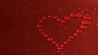 Gouttes d'eau en forme de cœur rouges symbolisant l'amour