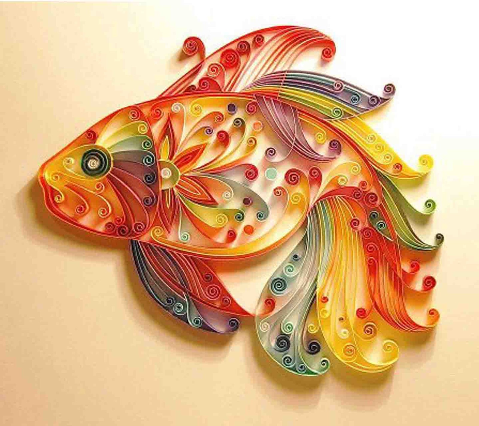 A close up of a colorful fish made of paper with swirly designs (fish, paper)