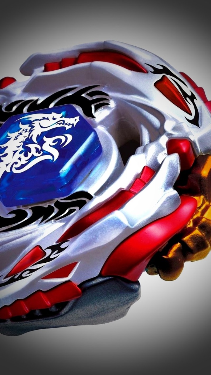 A close up of a toy with a dragon on it (beyblade, burst, motor)