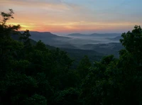 Nascer do sol sobre montanhas enevoadas: Uma paisagem serena da natureza selvagem