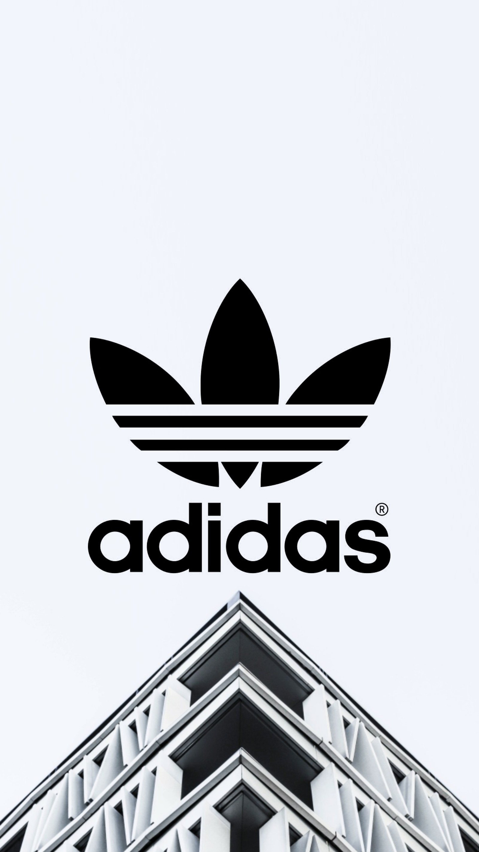 Logo de adidas en un edificio frente a un cielo blanco (minimalista, blanco)