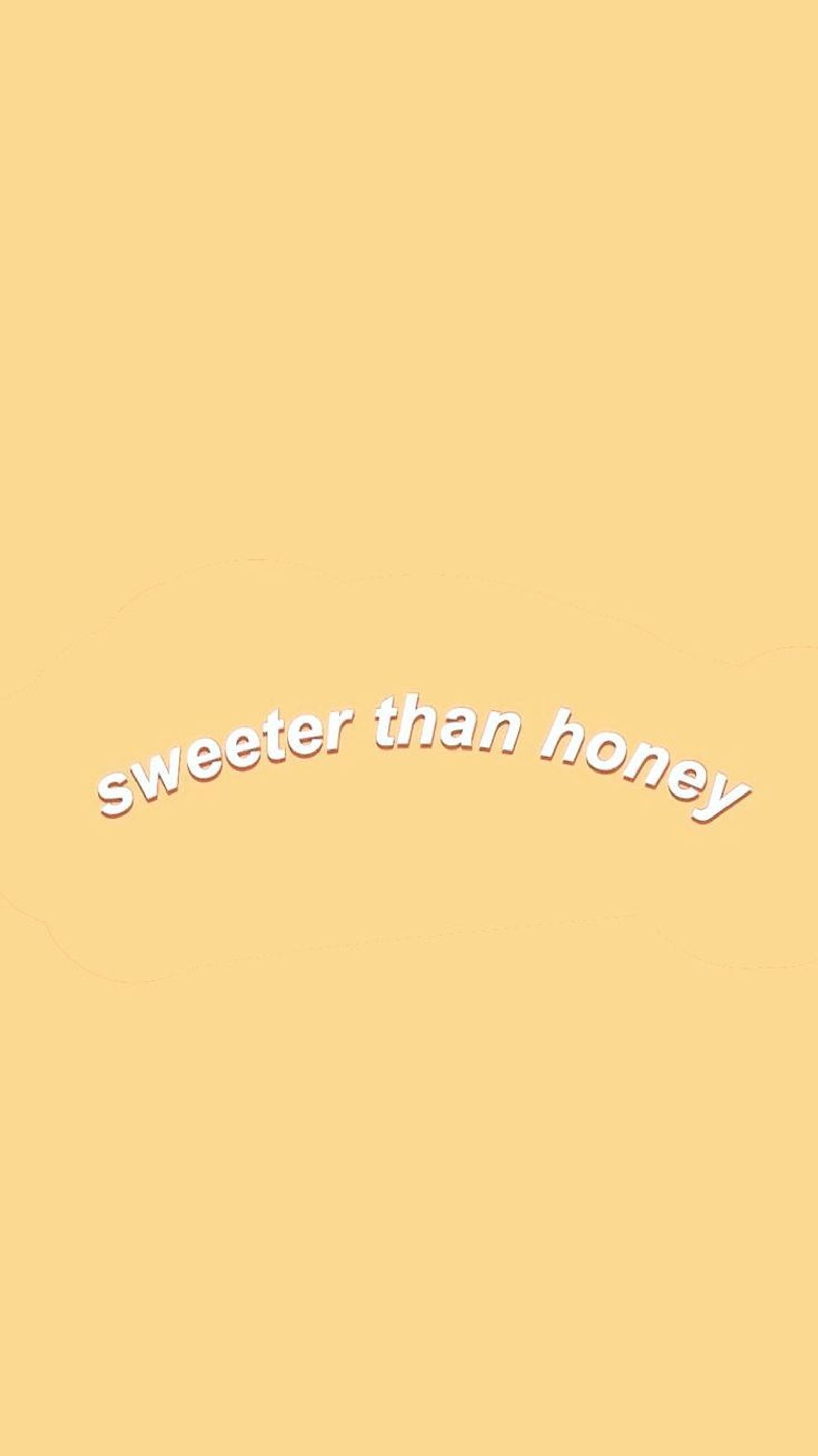 There is a yellow wall with a white text that says sweeter than grey (sweet, pastel yellow, yellow, sweeter that honey, aesthetic)