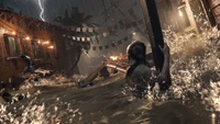 Lara Croft navigue dans un village inondé au milieu d'un orage dans Shadow of the Tomb Raider