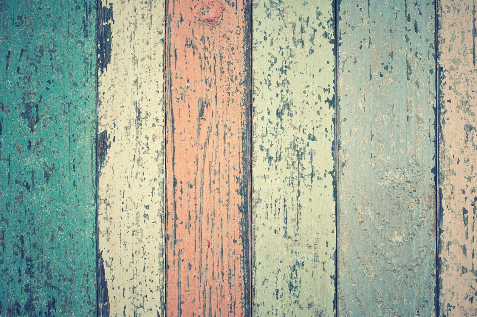 A close up of a wooden wall with peeling paint (brown, colorfulness, blue, green, wood)