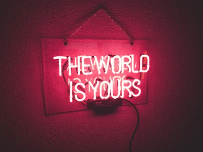 Glowing Neon Sign: The World Is Yours on a Red Background