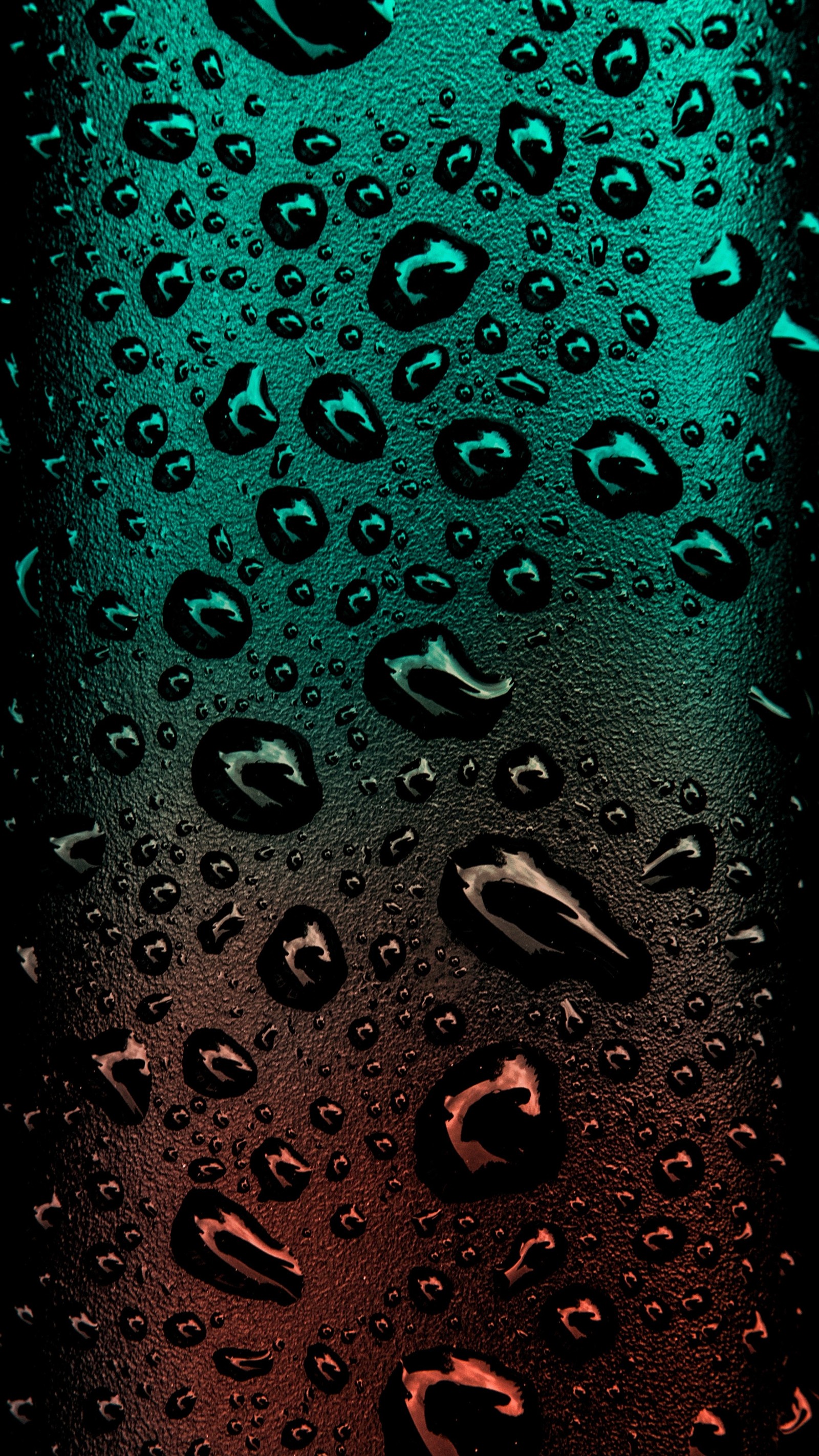 A close up of a glass with water droplets on it (water, green, drop, moisture, dew)