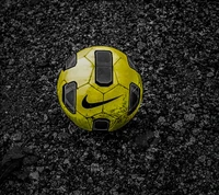 Worn Yellow Soccer Ball on Gravel Surface