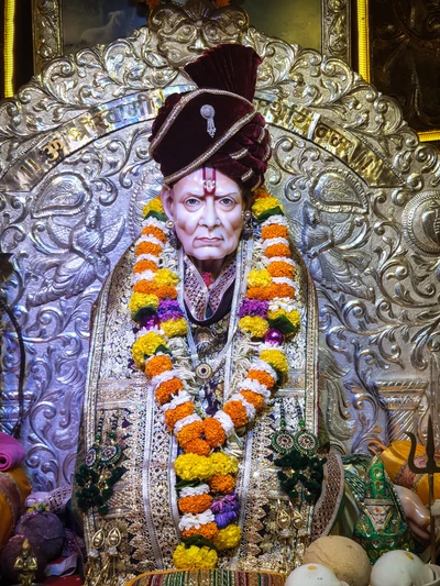 Divine Presence of Swami Samarth with Ornate Decor and Floral Offerings