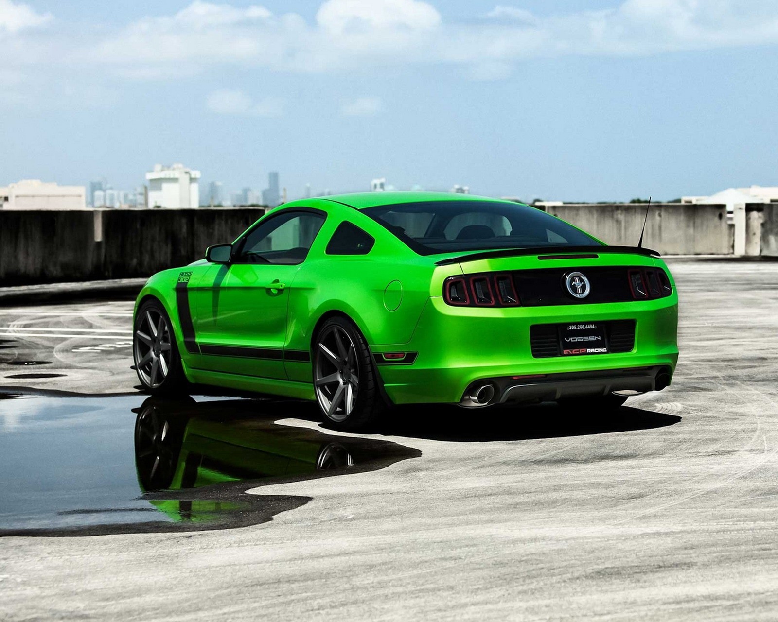 A close up of a green mustang parked on a parking lot (car, ford mustang)