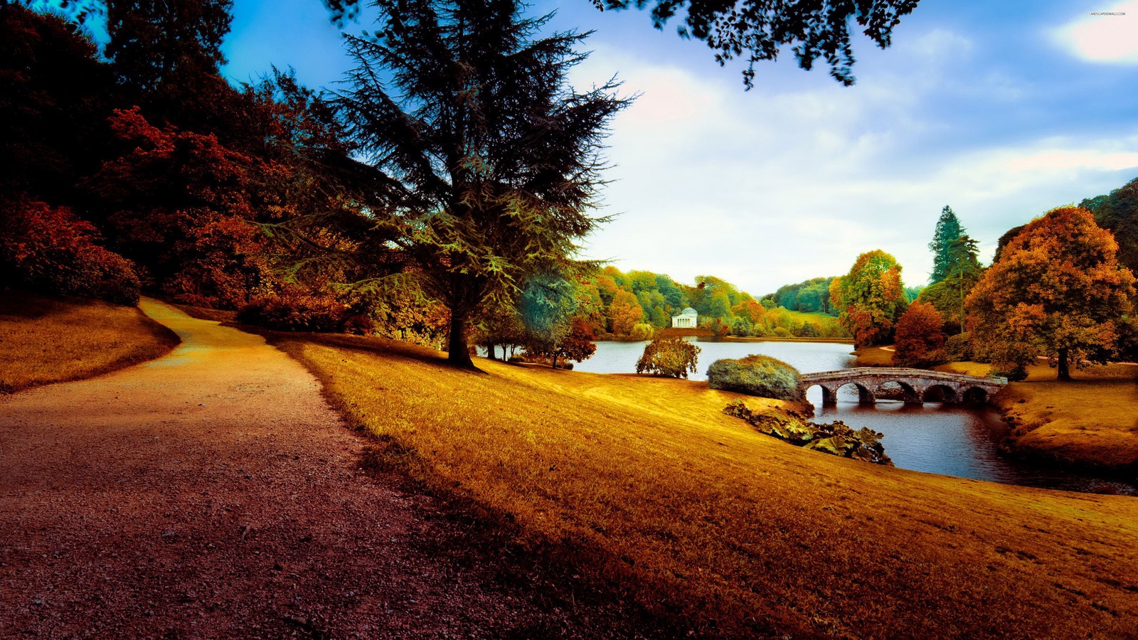 Arafed view of a bridge over a river in a park (landscape, nature, tree, reflection, sunlight)