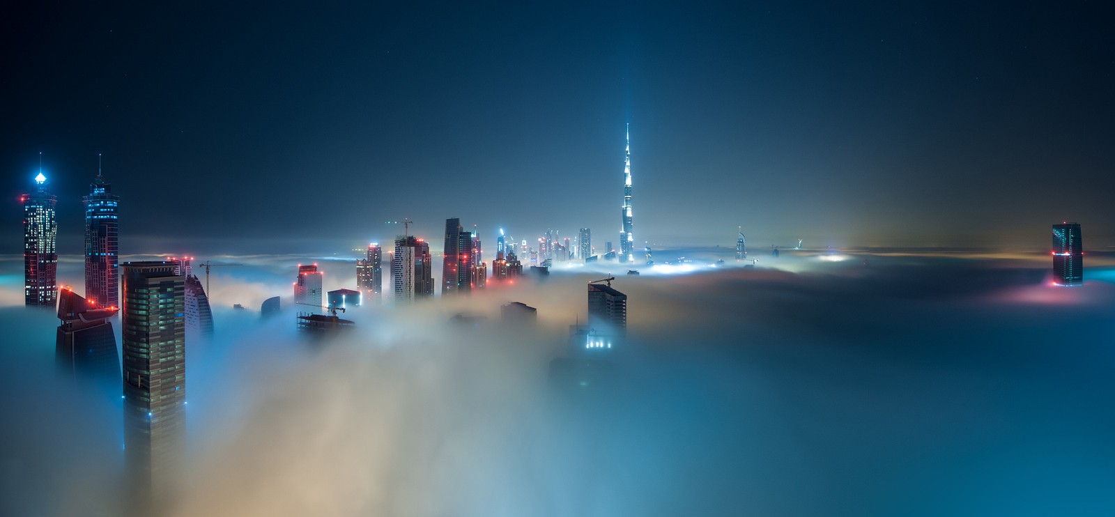 Una vista del horizonte de la ciudad desde encima de las nubes de noche (burj khalifa, rascacielos, nube, agua, ciudad)