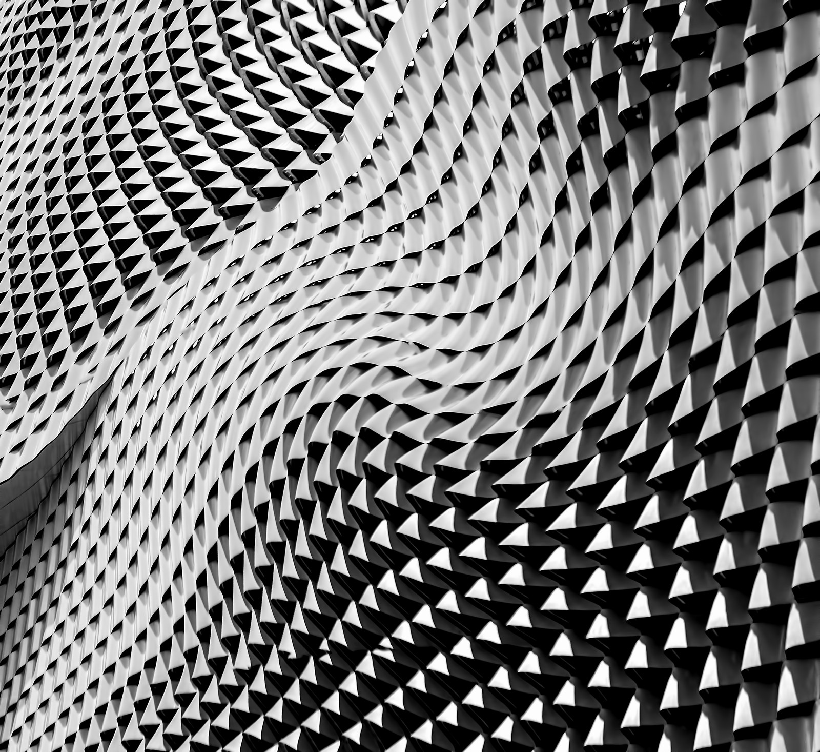 A close up of a black and white photo of a building (pattern, mesh, metal, monochrome, design)