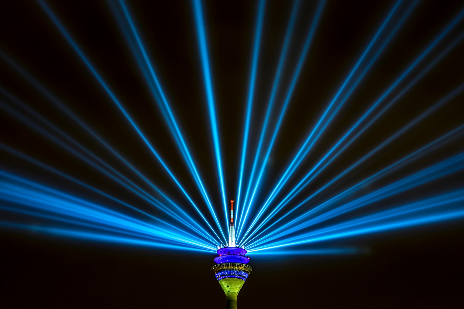 Arafed image of a tower with a blue light beam (rhine tower, rheinturm, düsseldorf, germany, television tower)