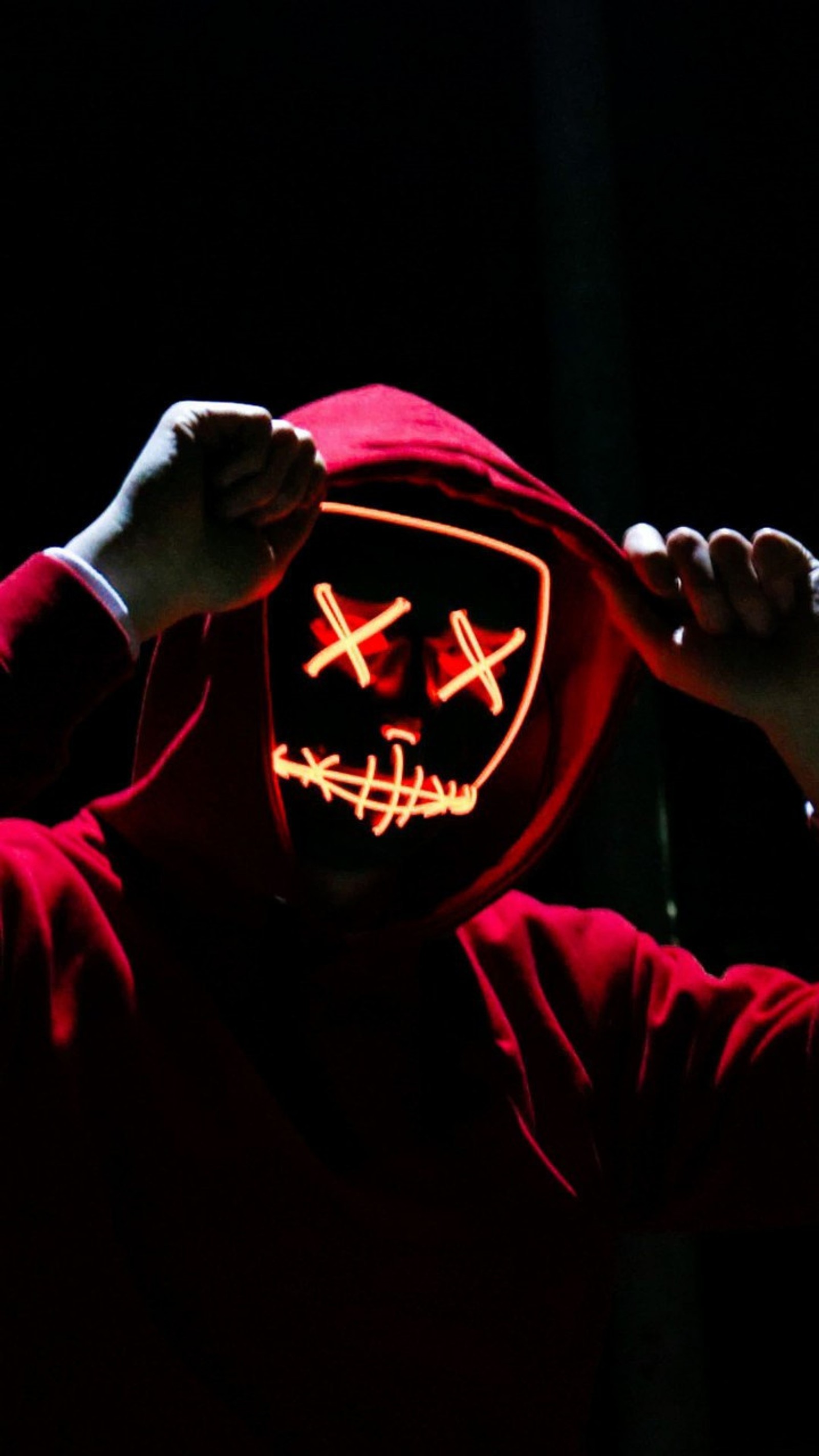 Arafed man in a red hoodie with a neon mask on (movie, halloween, red)