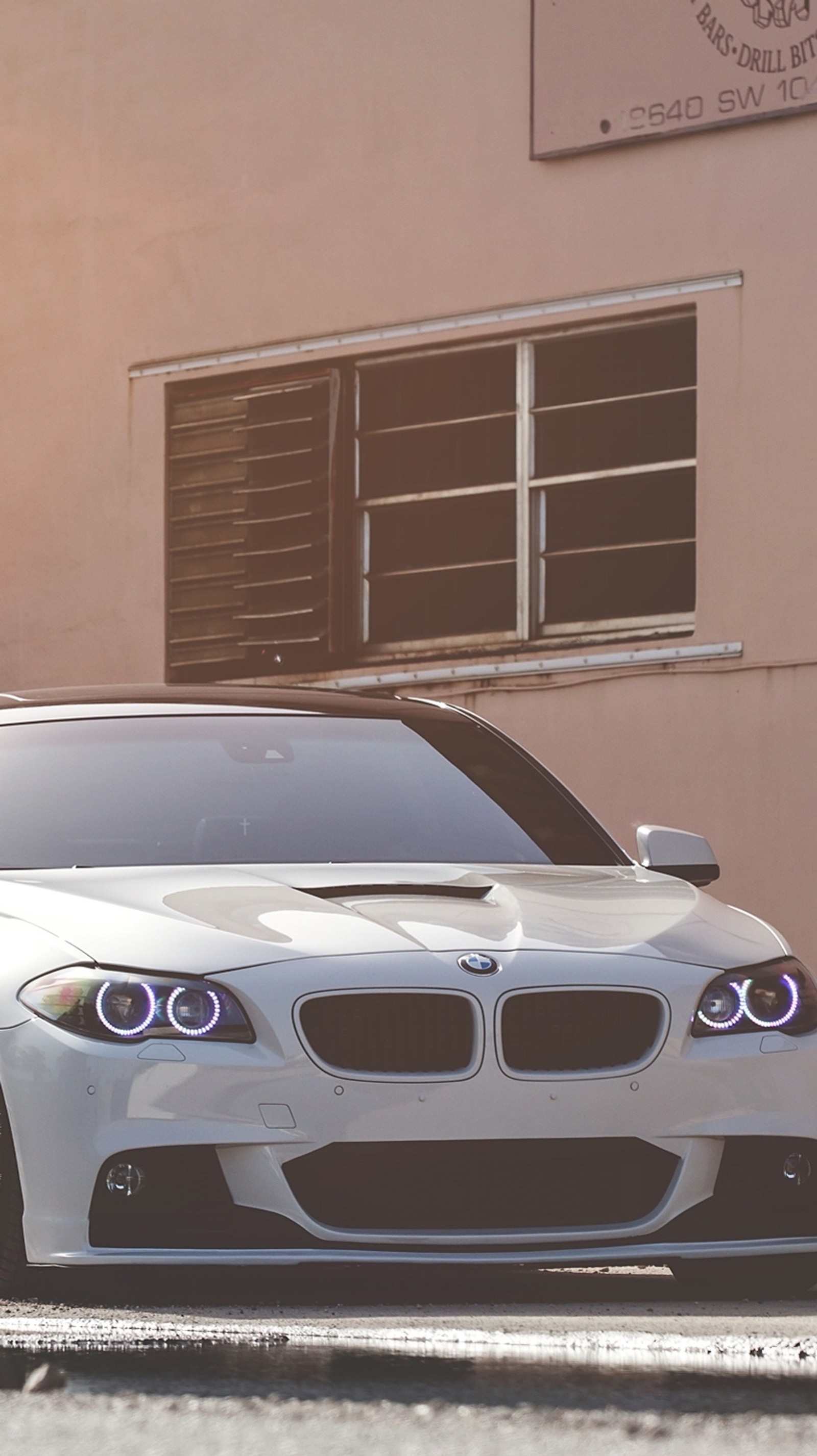 Arafed white bmw car parked in front of a building (car, good, nice)