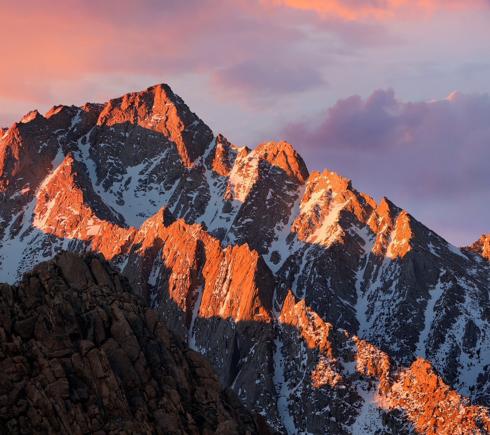 Mountains with snow on them and a pink sky in the background (apple, mac, macos, mountain, sierra)