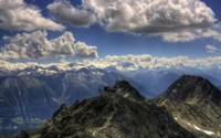 Majestic Mountain Range Under a Dramatic Sky at Sunset