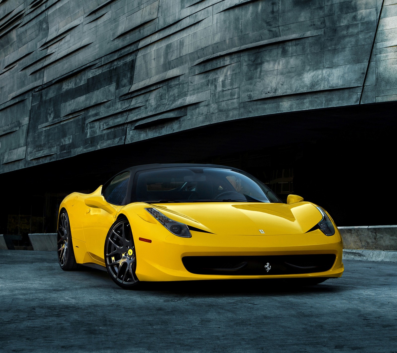 A yellow sports car parked in front of a building (car, yellow)