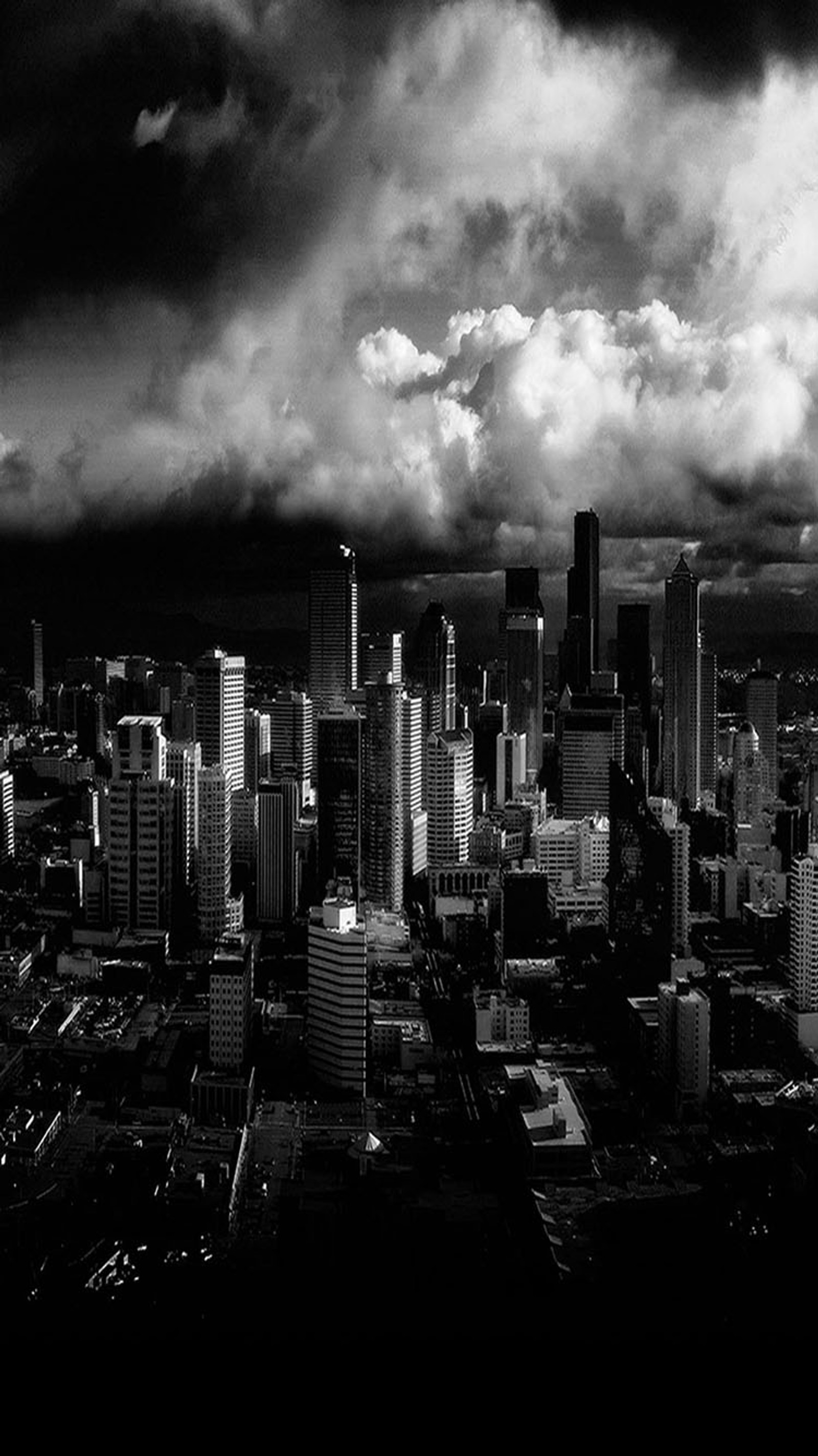 Vue aérienne d'une ville avec un ciel nuageux et quelques bâtiments (ville, sombre)