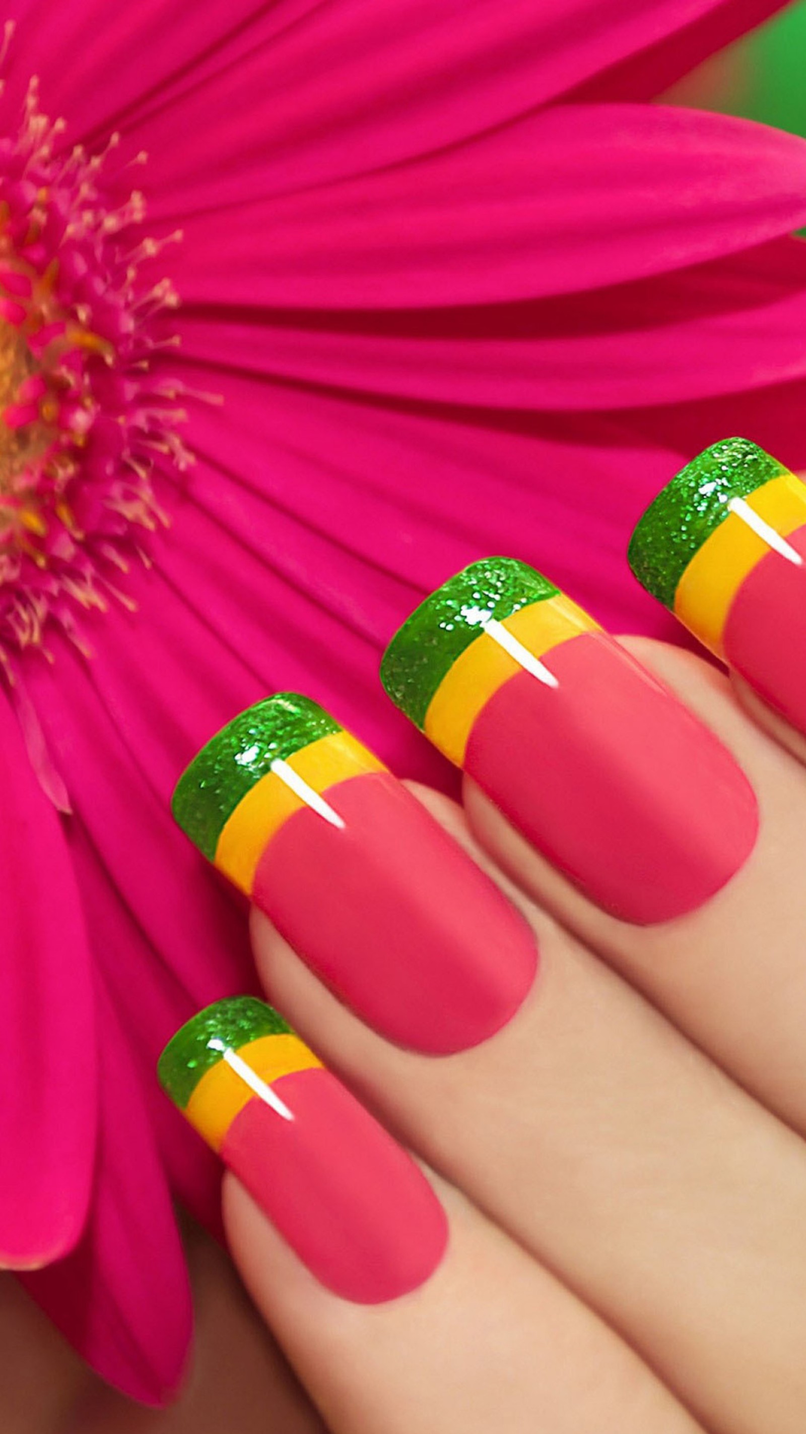 Someone has a pink flower and a yellow and green manicure (color, flower, manicure)