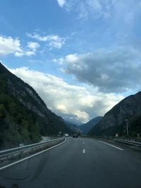 Majestic Mountain Highway Under a Cloudy Sky