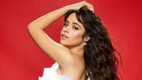 Camila Cabello: Radiant Elegance Against a Bold Red Background