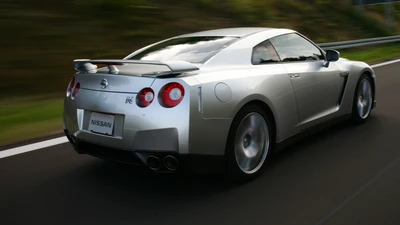 Nissan GT-R: A sleek silver supercar in motion, showcasing its iconic design and performance.