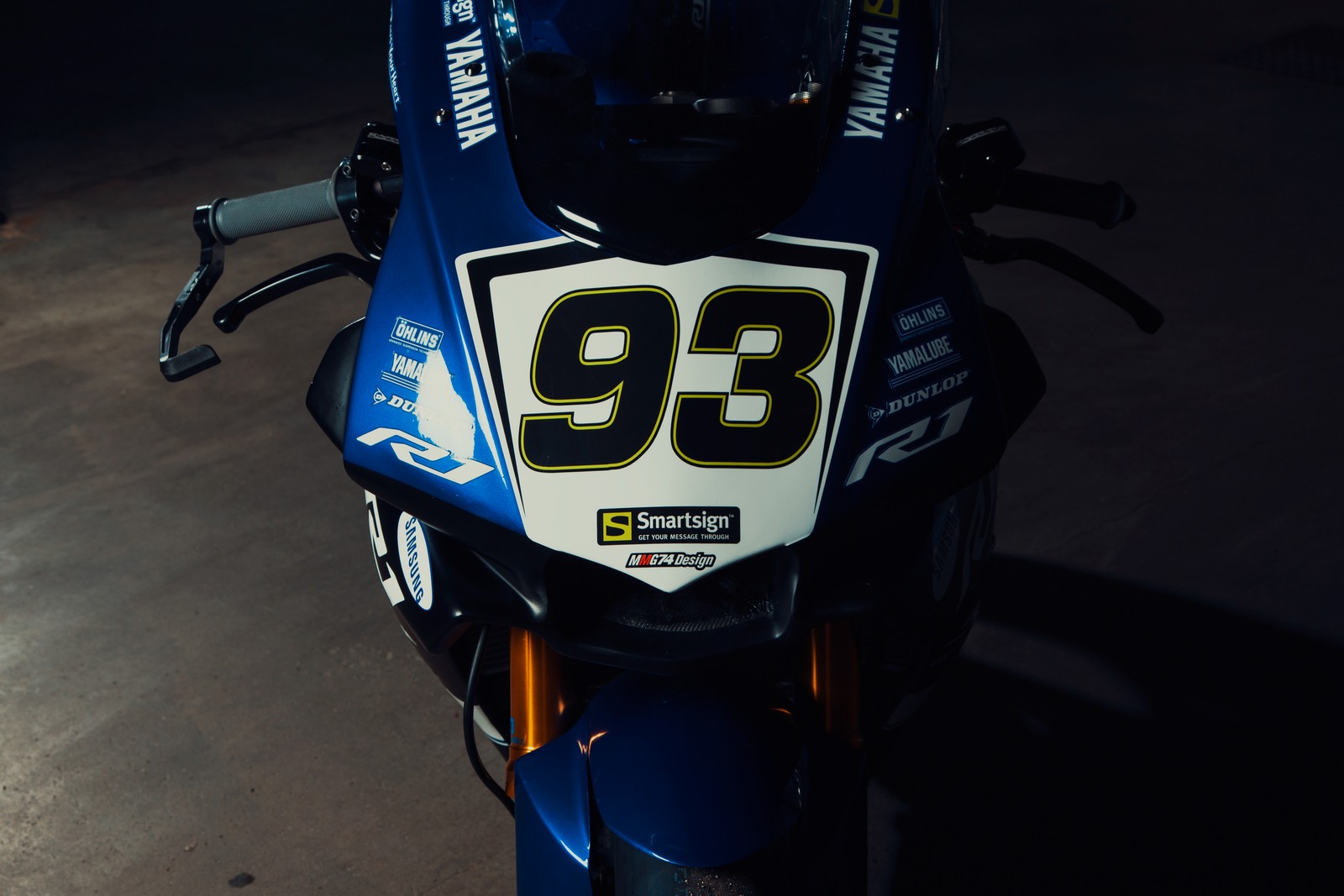 There is a motorcycle with a number on the front of it (motorcycle, headlamp, car, yamaha motor company, yamaha yzf)