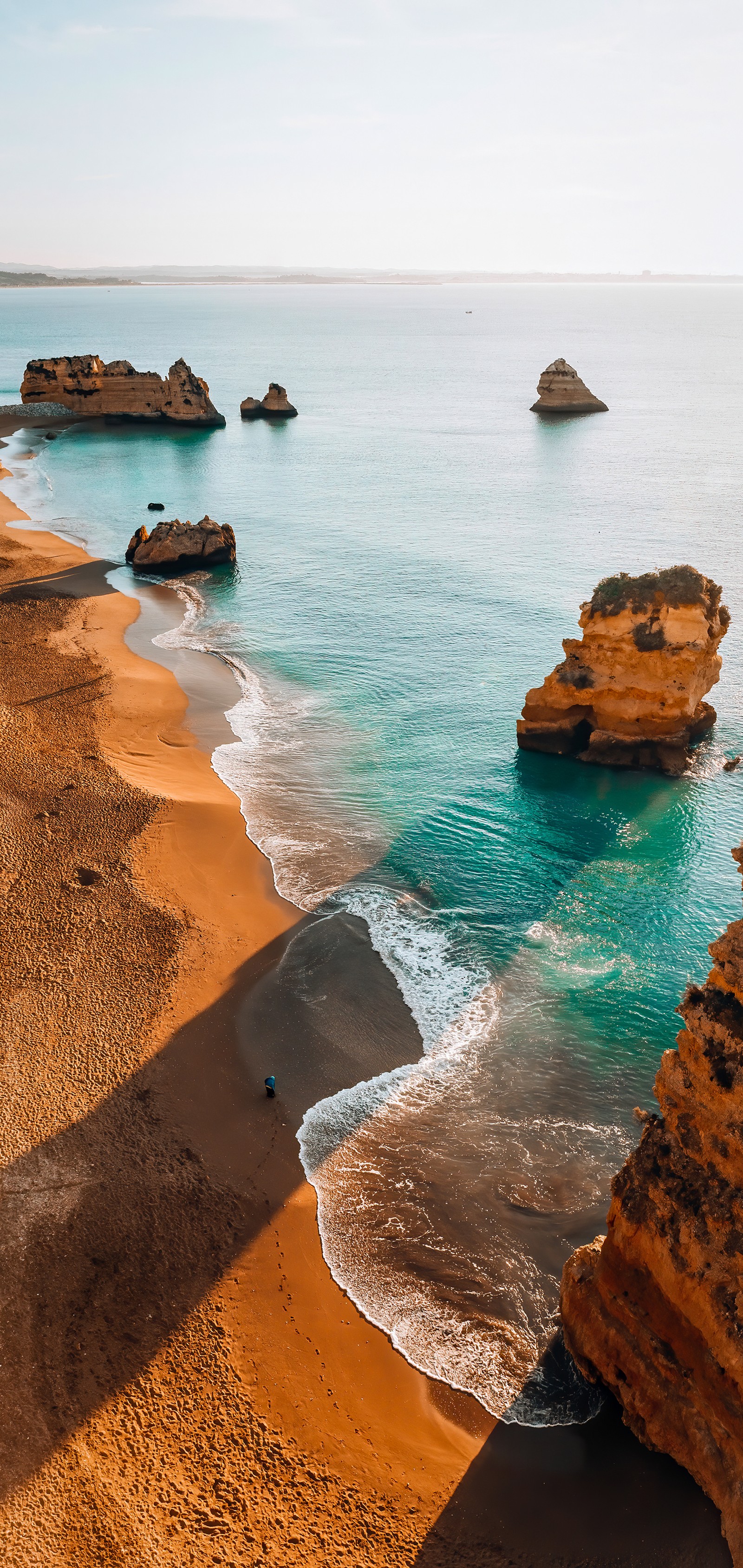 There is a person walking on the beach near the water (landscape, landscape painting, painting, water, water resources)